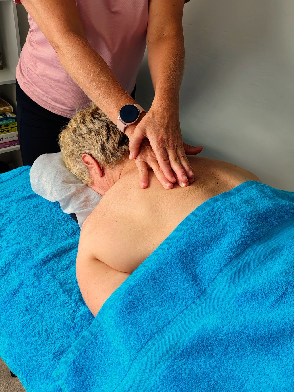Massage therapist massaging client's back